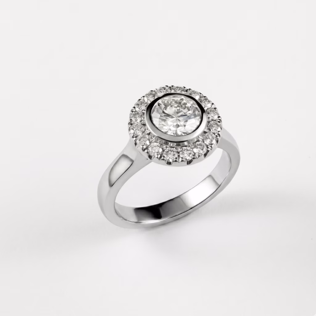A high-end platinum engagement ring showcasing a central round brilliant-cut diamond completely surrounded by a sparkling halo of smaller pave-set diamonds, all set against a clean white background.