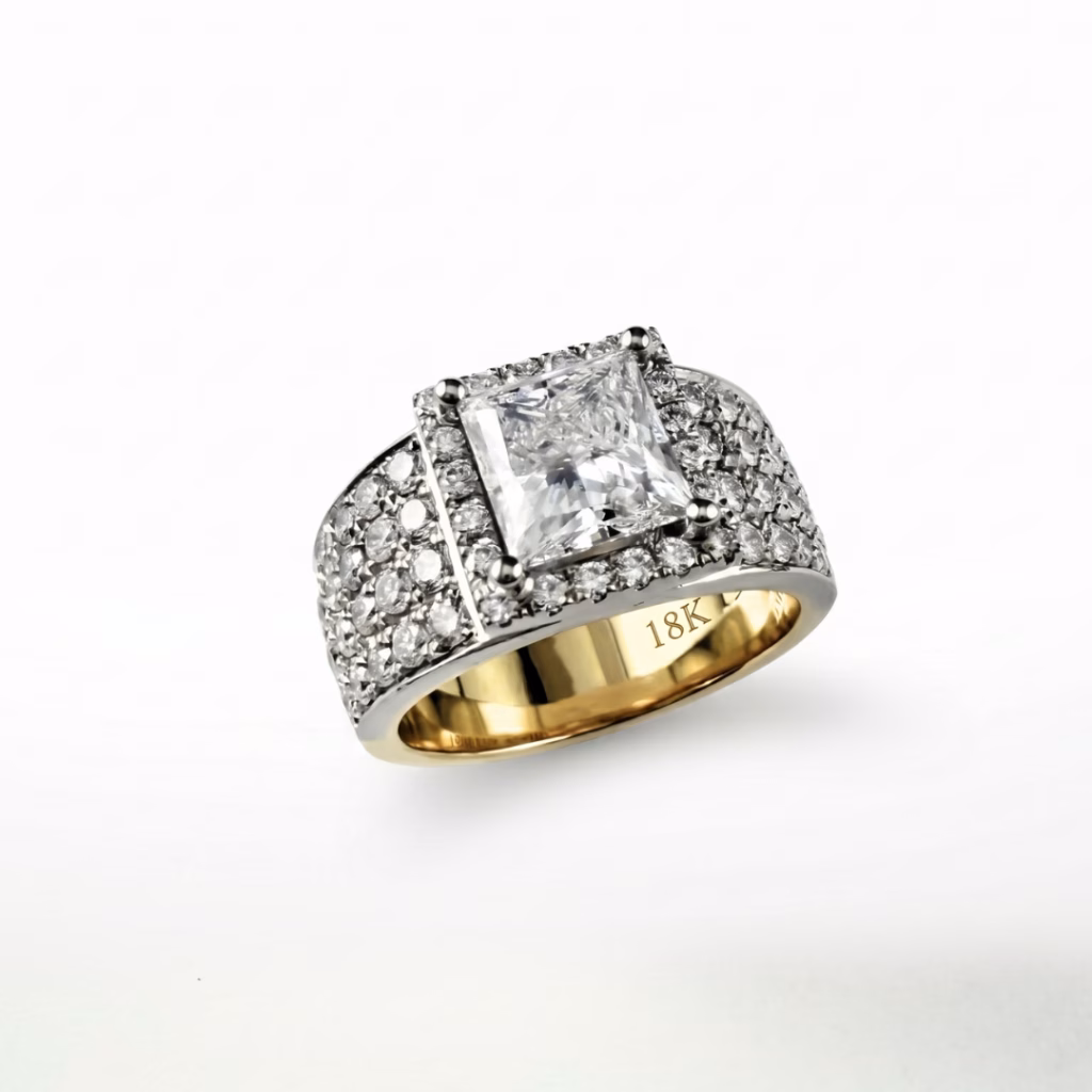 A detailed view of a custom diamond band-style ring featuring a large, central princess-cut diamond, completely framed by pave-set diamonds, with "18K" clearly engraved on the inner yellow gold band.
