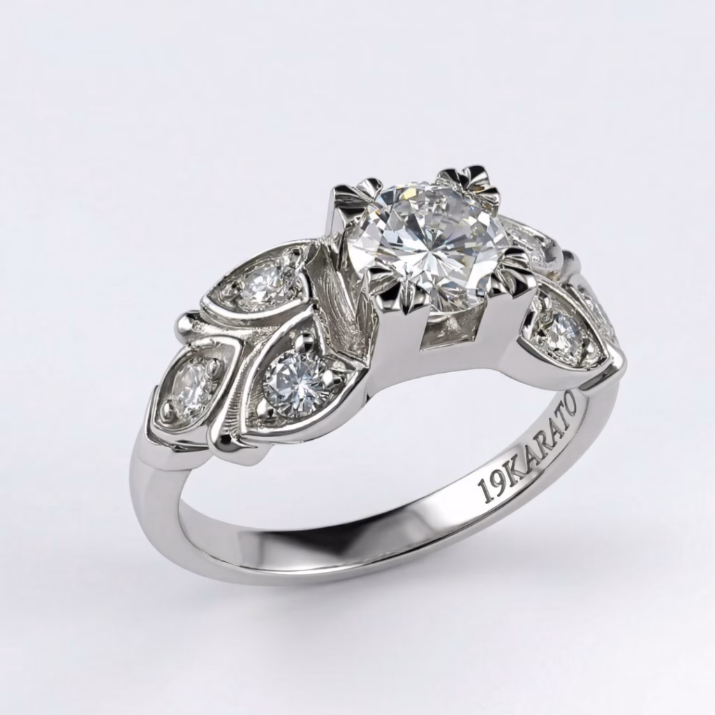 Vintage-style 19K white gold engagement ring by Arato featuring a round brilliant center diamond and delicate diamond-set leaf motifs.