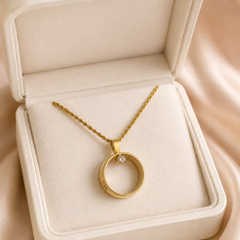 14K yellow gold circle pendant with a bezel-set diamond displayed in a luxury jewellery presentation box.